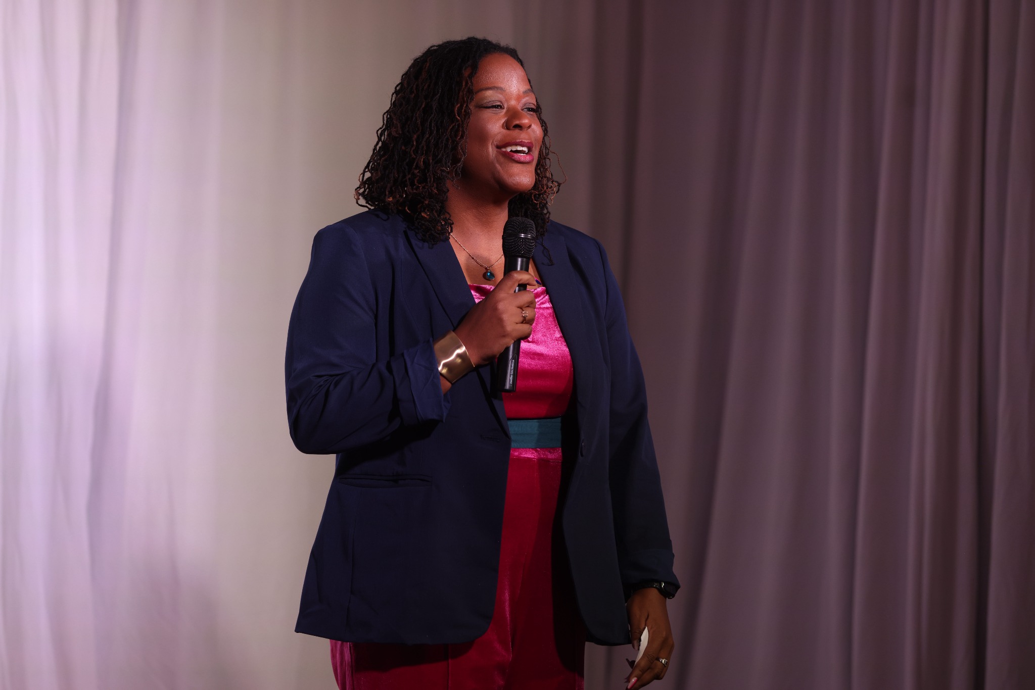 Tiffany Blessing speaking onstage with a microphone