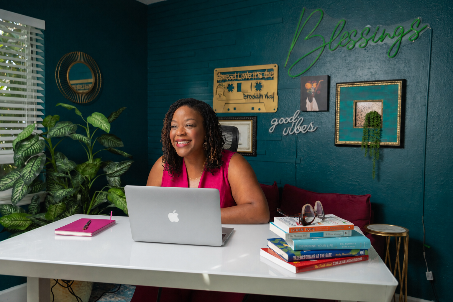 Tiffany Blessing smiling at her desk with her laptop open